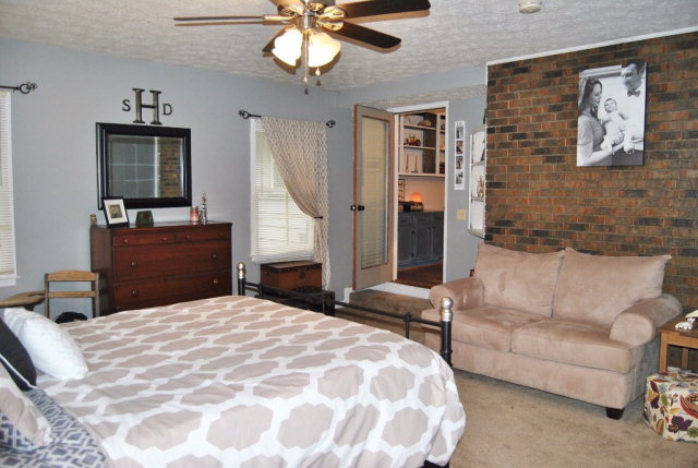 6298 Thomaston Road Macon, GA 31220 - Photo 15 of 33 a bedroom with a large bed and a chandelier