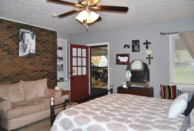 6298 Thomaston Road Macon, GA 31220 - Photo 18 of 33 a bedroom with a bed ceiling fan and a large mirror