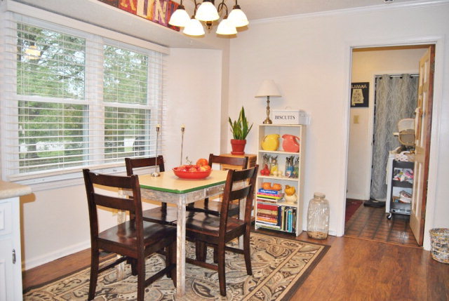 6298 Thomaston Road Macon, GA 31220 - Photo 26 of 33 a dining room with furniture wooden floor a rug a potted plant and a chandelier