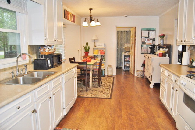 6298 Thomaston Road Macon, GA 31220 - Photo 27 of 33 a kitchen with stainless steel appliances a lot of counter space and wooden floors