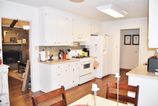 6298 Thomaston Road Macon, GA 31220 - Photo 30 of 33 a kitchen with stainless steel appliances white cabinets and wooden floor