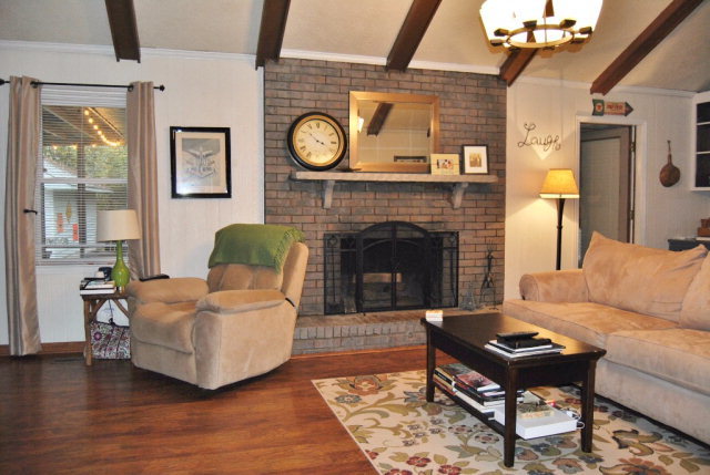 6298 Thomaston Road Macon, GA 31220 - Photo 31 of 33 a living room with furniture a clock and a fireplace