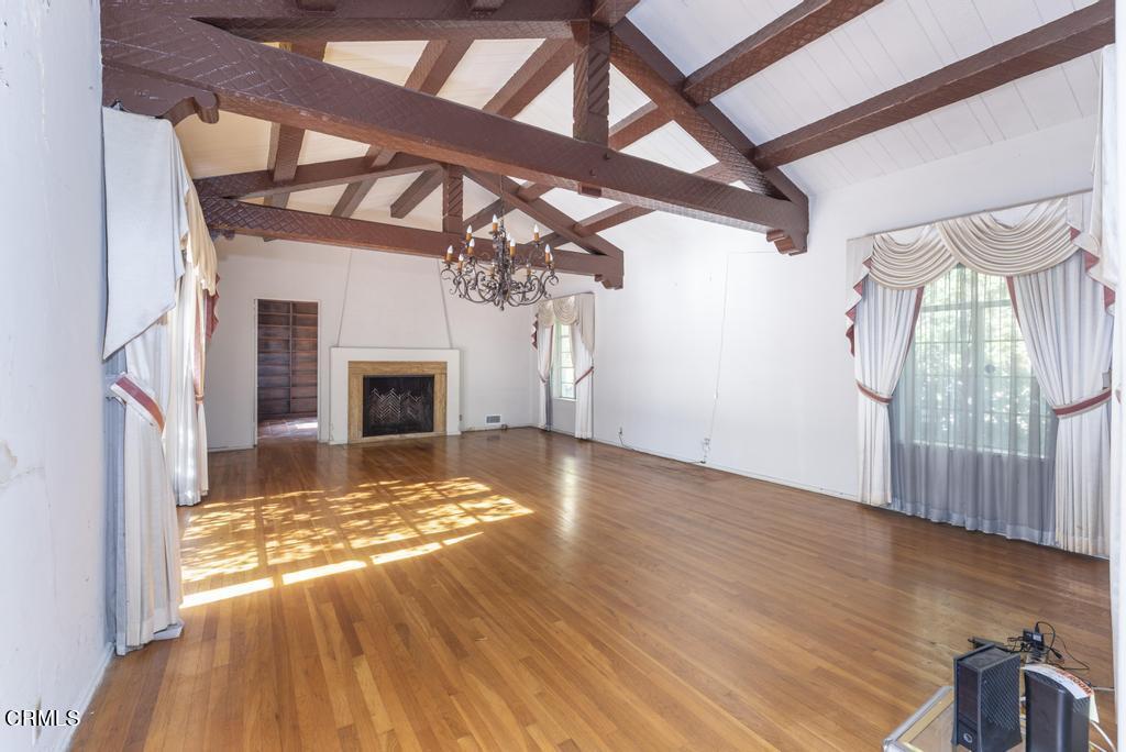 893 Gainsborough Drive Pasadena, CA 91107 - Photo 12 of 62 a view of empty room with wooden floor and fireplace