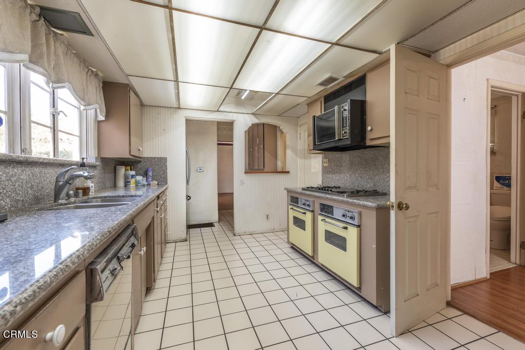 893 Gainsborough Drive Pasadena, CA 91107 - Photo 18 of 62 a kitchen with stainless steel appliances granite countertop a stove a sink and a refrigerator