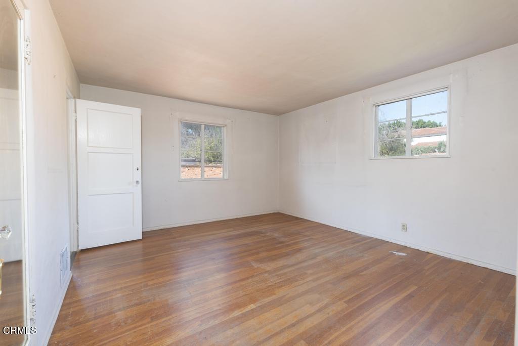 893 Gainsborough Drive Pasadena, CA 91107 - Photo 21 of 62 an empty room with wooden floor and windows