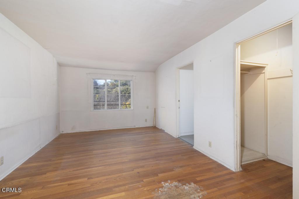 893 Gainsborough Drive Pasadena, CA 91107 - Photo 25 of 62 an empty room with wooden floor cabinet and windows