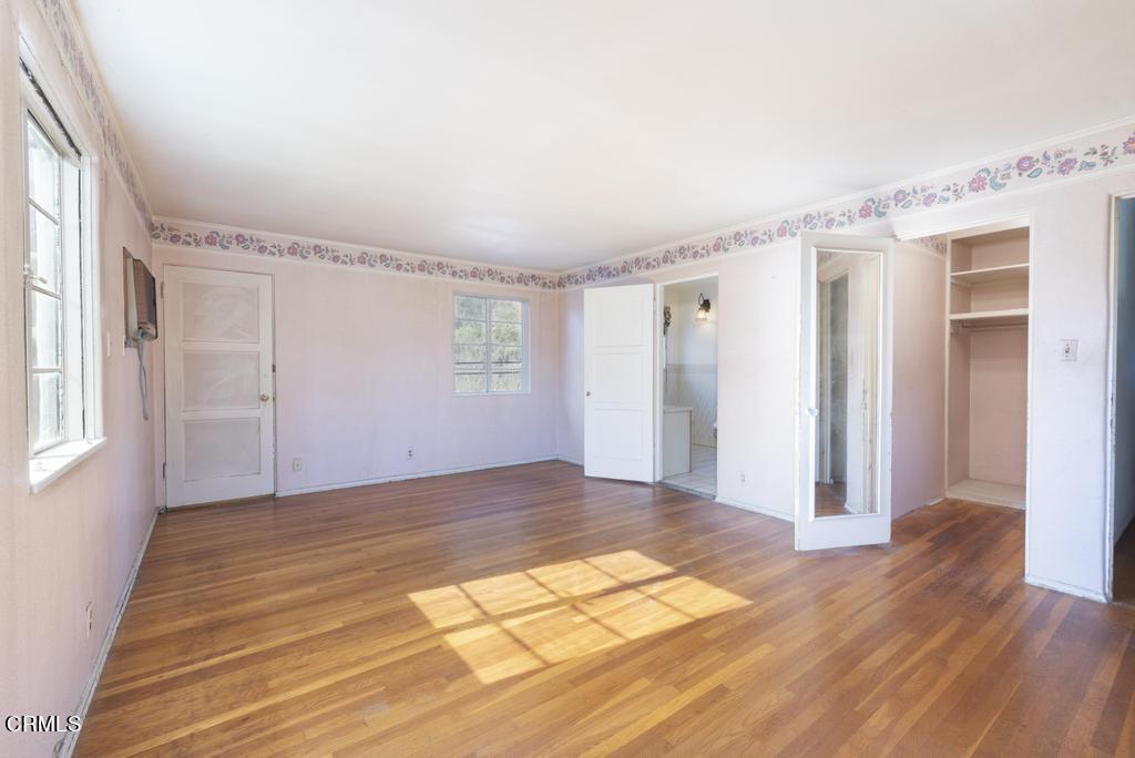 893 Gainsborough Drive Pasadena, CA 91107 - Photo 28 of 62 a view of an empty room with wooden floor and a window