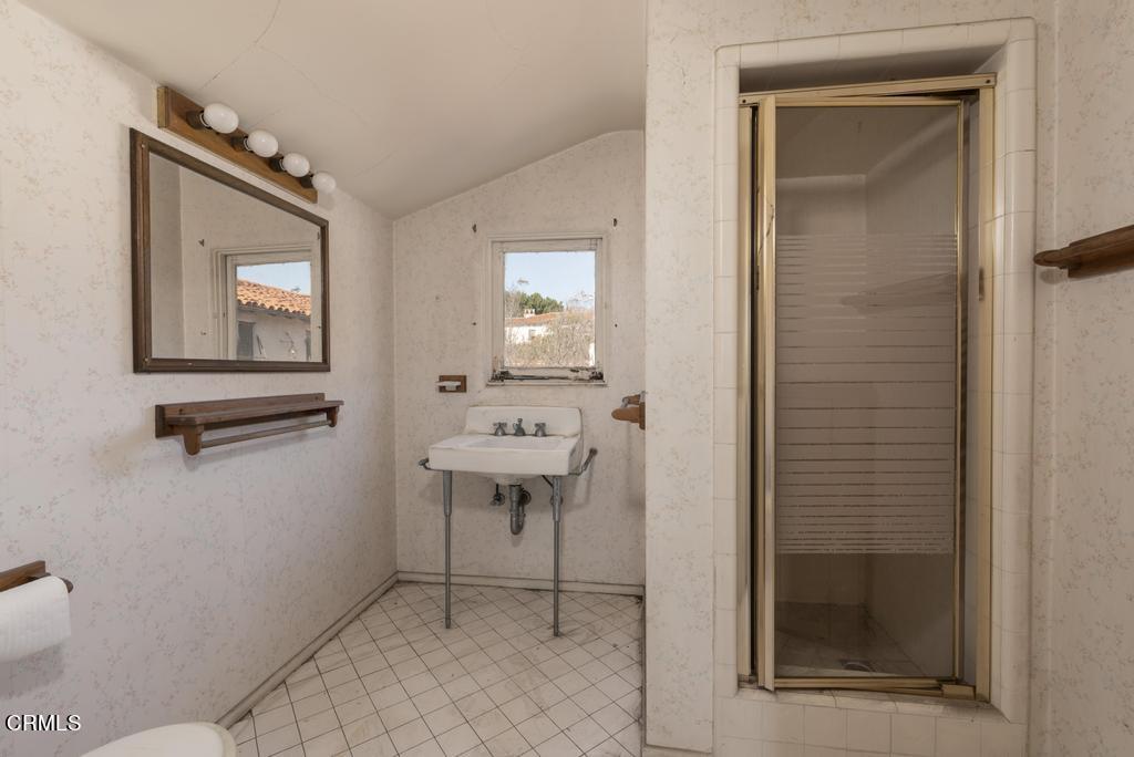 893 Gainsborough Drive Pasadena, CA 91107 - Photo 34 of 62 a bathroom with a sink a mirror and a shower