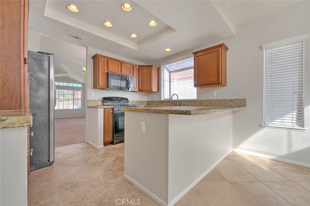 39220 Cala Del Valle Murrieta, CA 92562 - Photo 11 of 47 a kitchen with stainless steel appliances granite countertop a stove a sink a refrigerator and a oven