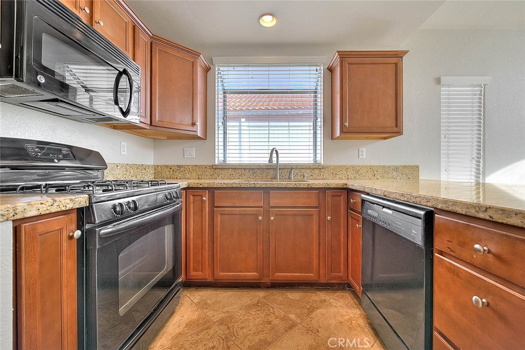 39220 Cala Del Valle Murrieta, CA 92562 - Photo 12 of 47 a kitchen with stainless steel appliances granite countertop a sink stove and cabinets