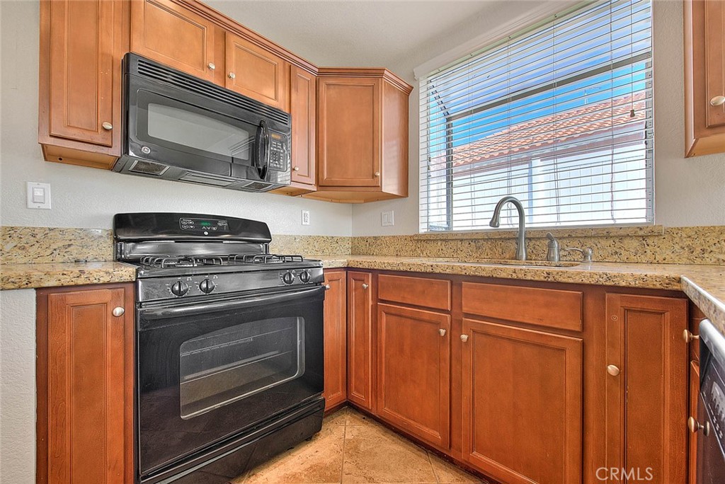 39220 Cala Del Valle Murrieta, CA 92562 - Photo 14 of 47 a kitchen with granite countertop cabinets stainless steel appliances and window
