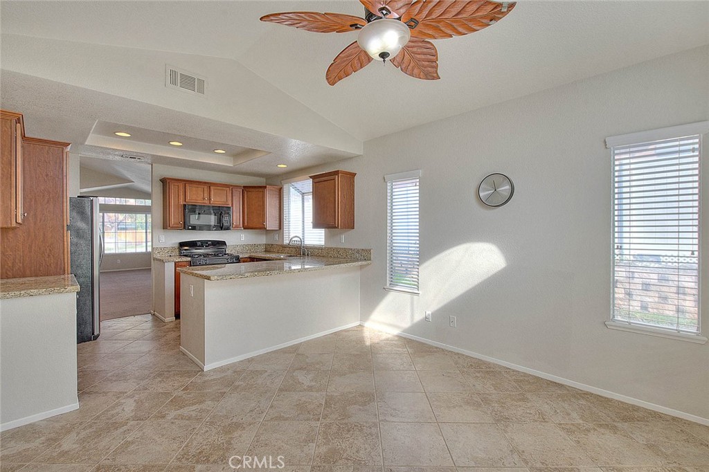 39220 Cala Del Valle Murrieta, CA 92562 - Photo 16 of 47 a kitchen with a refrigerator and microwave