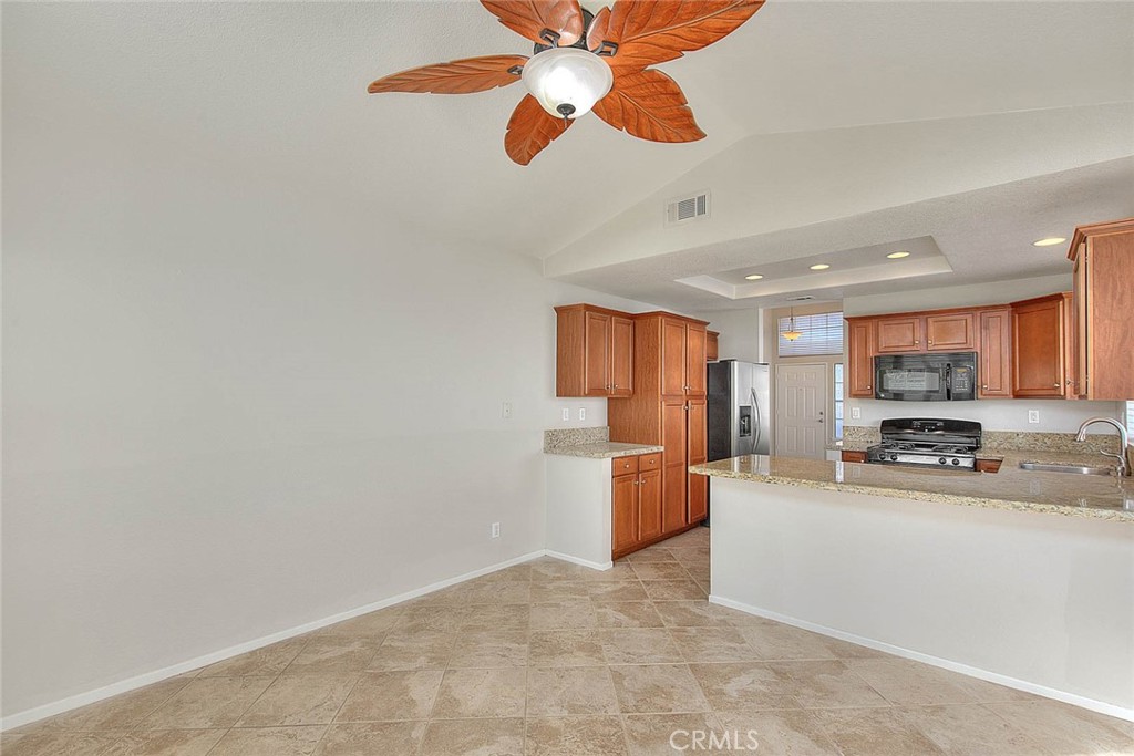 39220 Cala Del Valle Murrieta, CA 92562 - Photo 17 of 47 a kitchen with stainless steel appliances a stove top oven a sink a window and cabinets