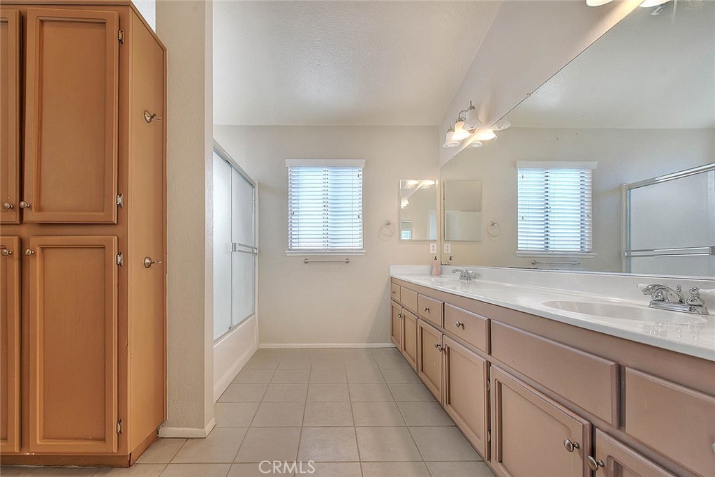 39220 Cala Del Valle Murrieta, CA 92562 - Photo 24 of 47 a spacious bathroom with a granite countertop sink a mirror and a
