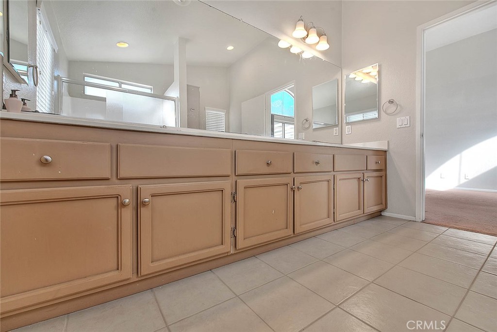 39220 Cala Del Valle Murrieta, CA 92562 - Photo 26 of 47 a bathroom with a sink and a mirror