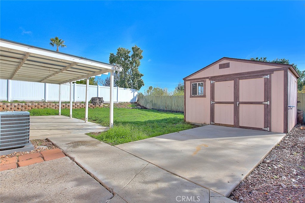 39220 Cala Del Valle Murrieta, CA 92562 - Photo 34 of 47 a front view of a house with a yard and garage