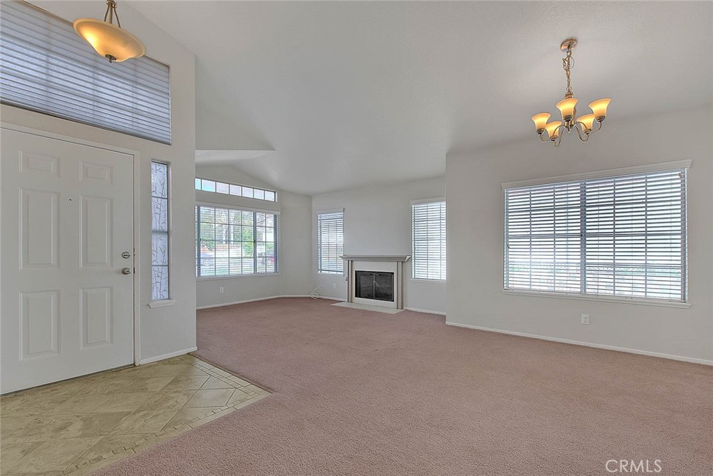 39220 Cala Del Valle Murrieta, CA 92562 - Photo 5 of 47 a view of an empty room with a window and fireplace