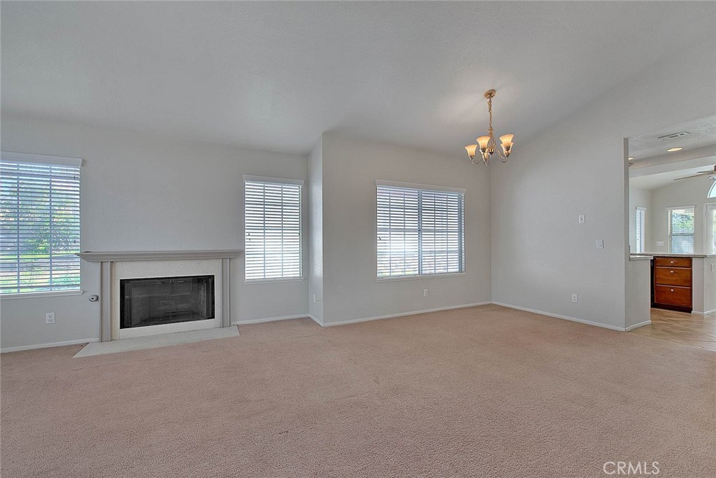 39220 Cala Del Valle Murrieta, CA 92562 - Photo 7 of 47 an empty room with windows and fireplace