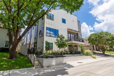 a view of a white house with a street