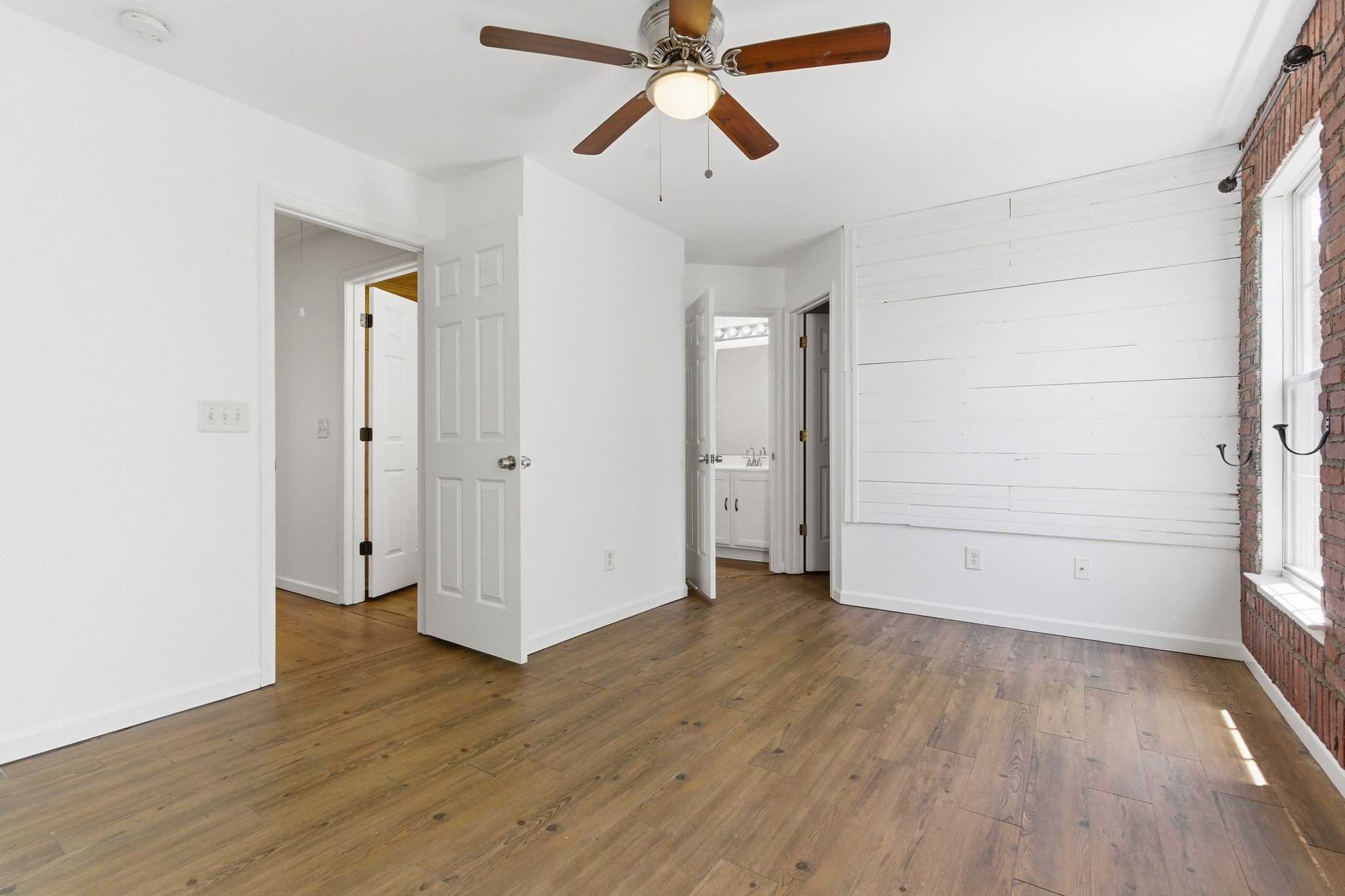 3401 Anderson Road, Unit 4 Antioch, TN 37013 - Photo 39 of 55 an empty room with wooden floor a ceiling fan and windows