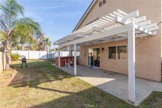 a view of a house with a swimming pool and sitting area