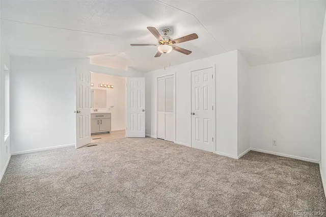a bathroom with a sink toilet vanity and shower