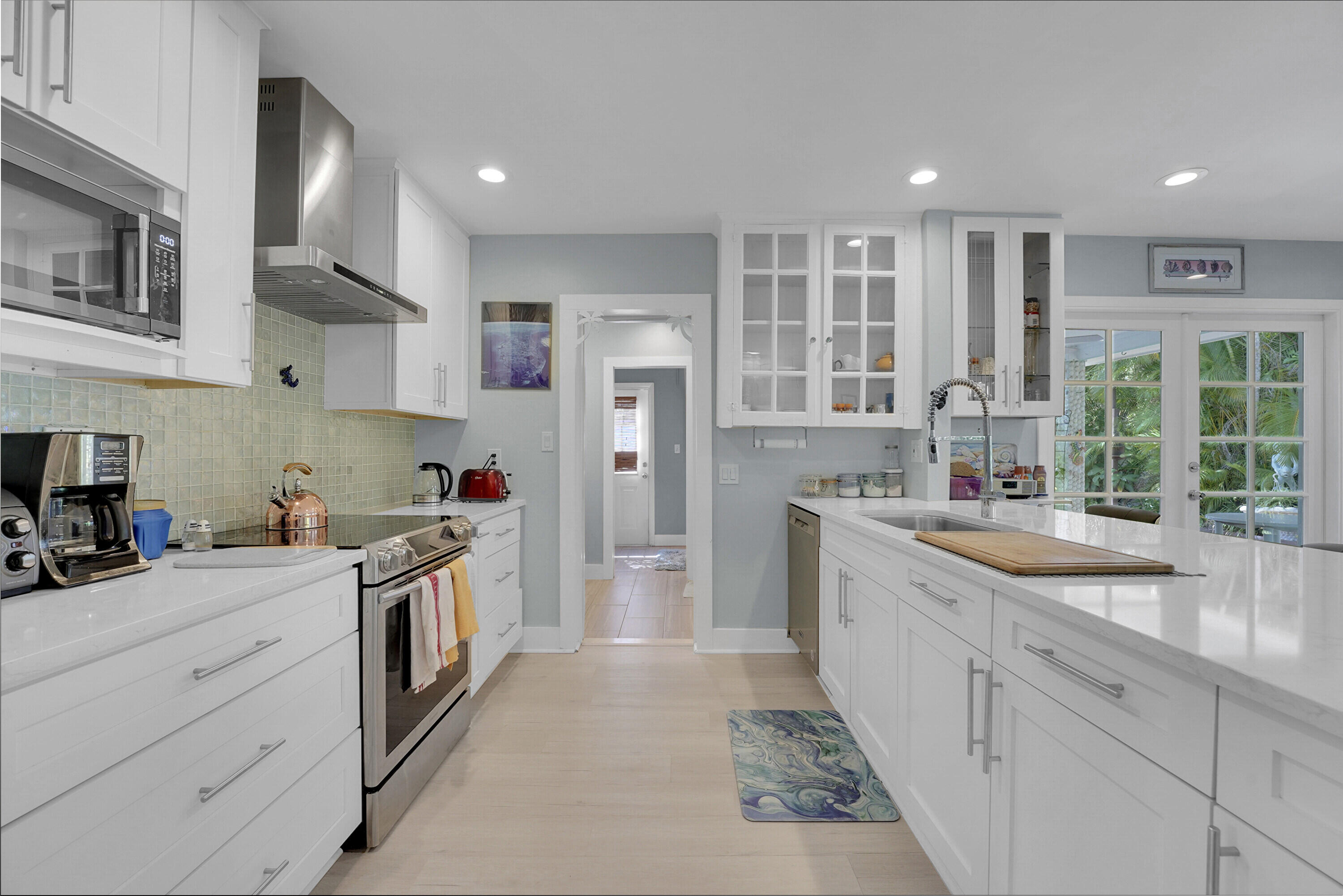 1708 Sunset Isles Road Fort Pierce, FL 34949 - Photo 14 of 52 a kitchen with a sink stove and refrigerator
