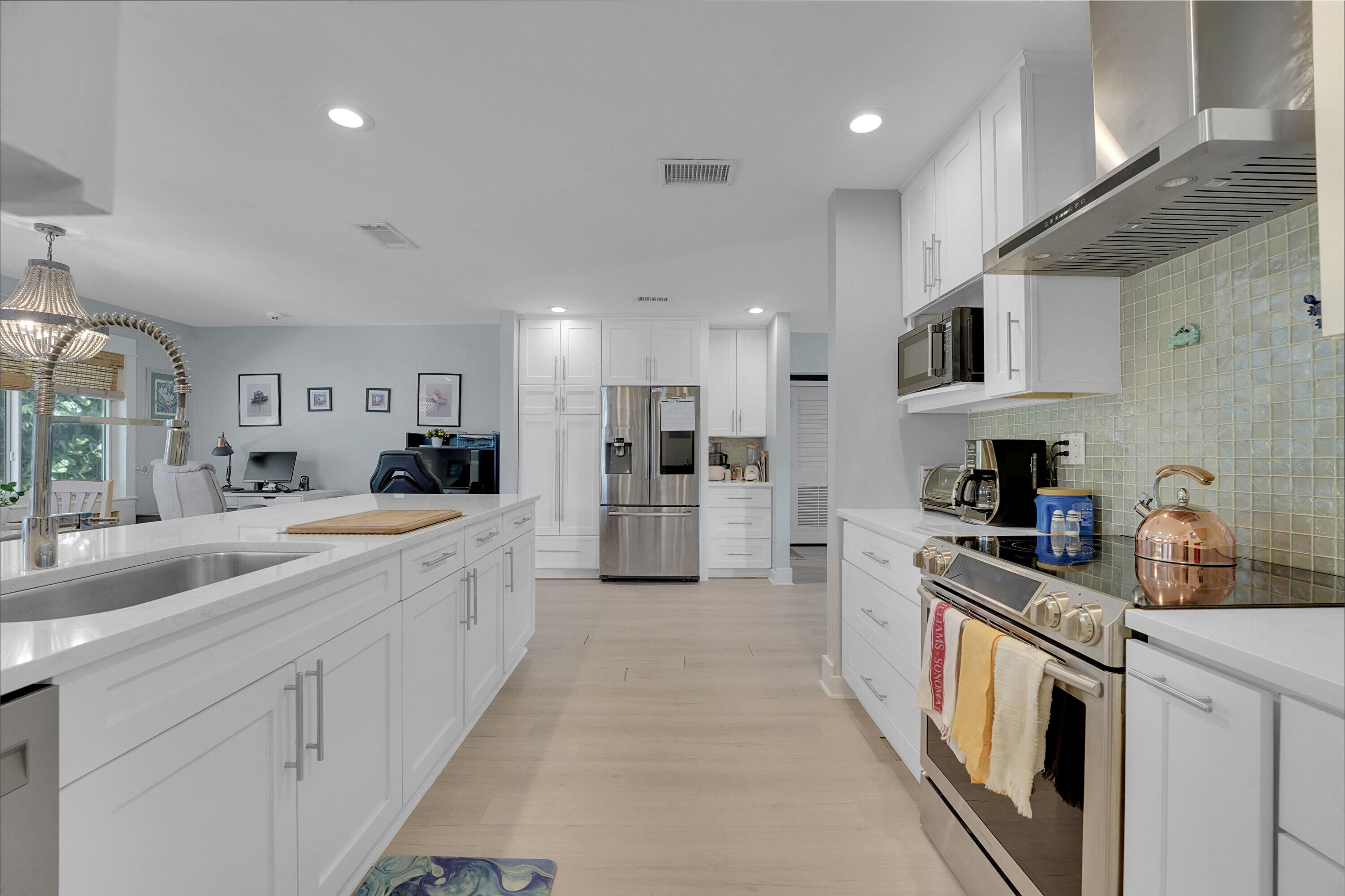 1708 Sunset Isles Road Fort Pierce, FL 34949 - Photo 15 of 52 a large kitchen with stainless steel appliances granite countertop a lot of cabinets a sink and a refrigerator