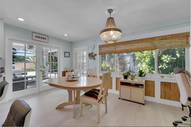 a view of a dining room with furniture wooden floor and chandelier