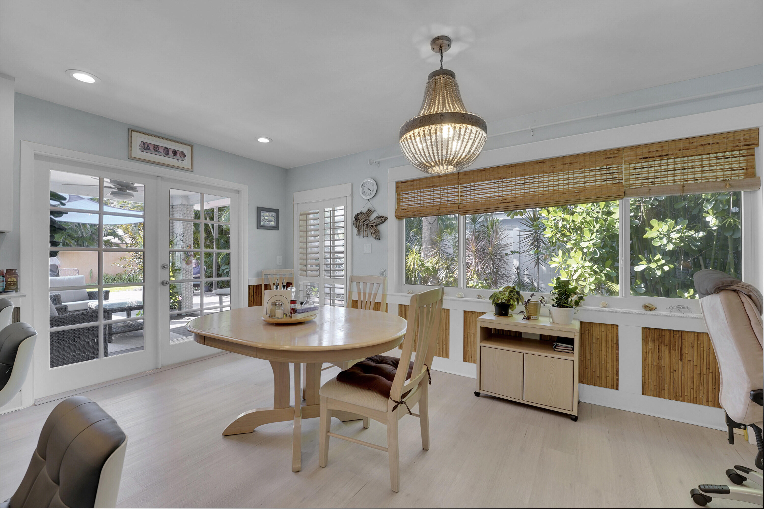 1708 Sunset Isles Road Fort Pierce, FL 34949 - Photo 16 of 52 a view of a dining room with furniture wooden floor and chandelier