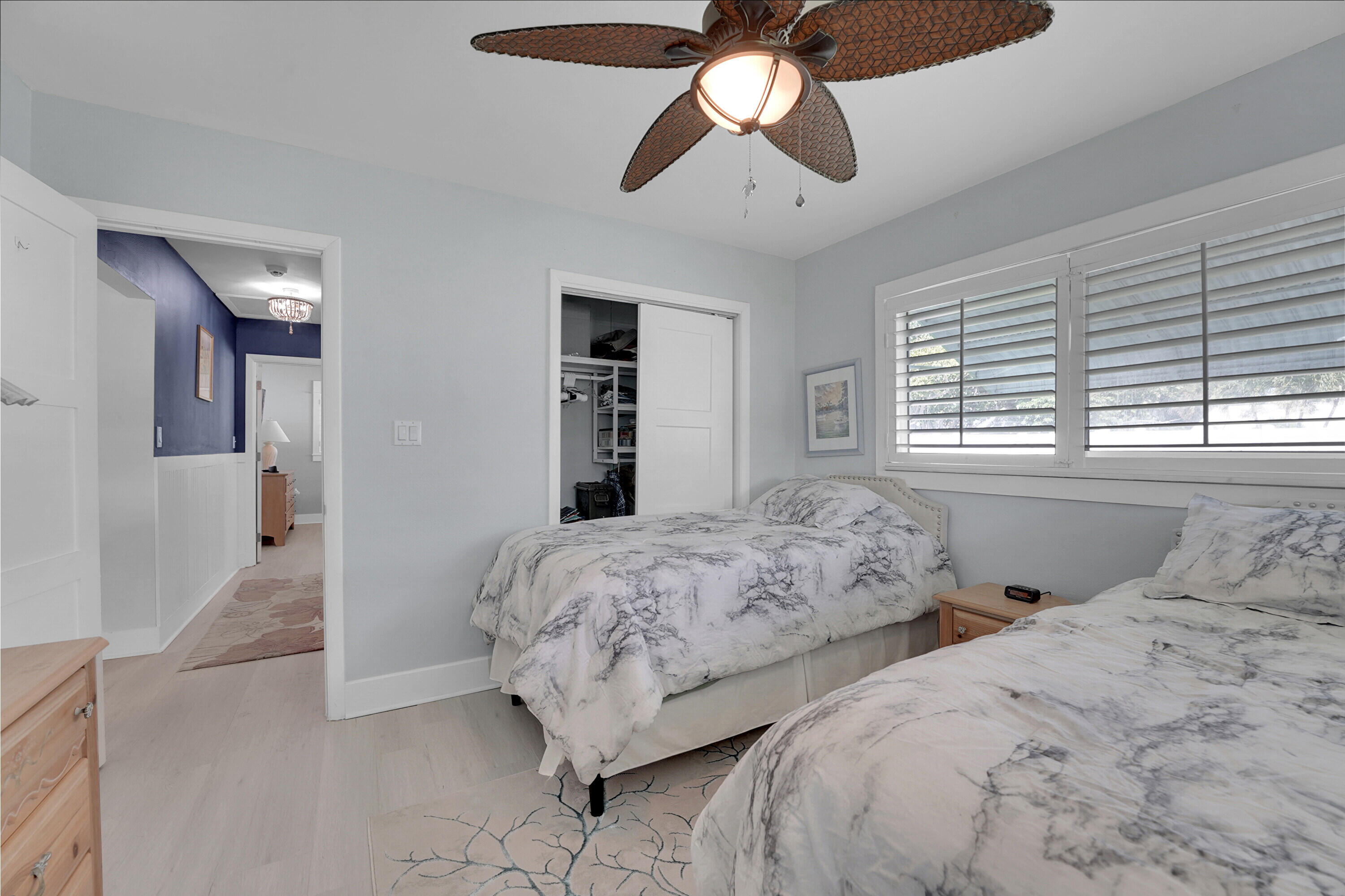 1708 Sunset Isles Road Fort Pierce, FL 34949 - Photo 18 of 52 a bedroom with two large bed and a chandelier