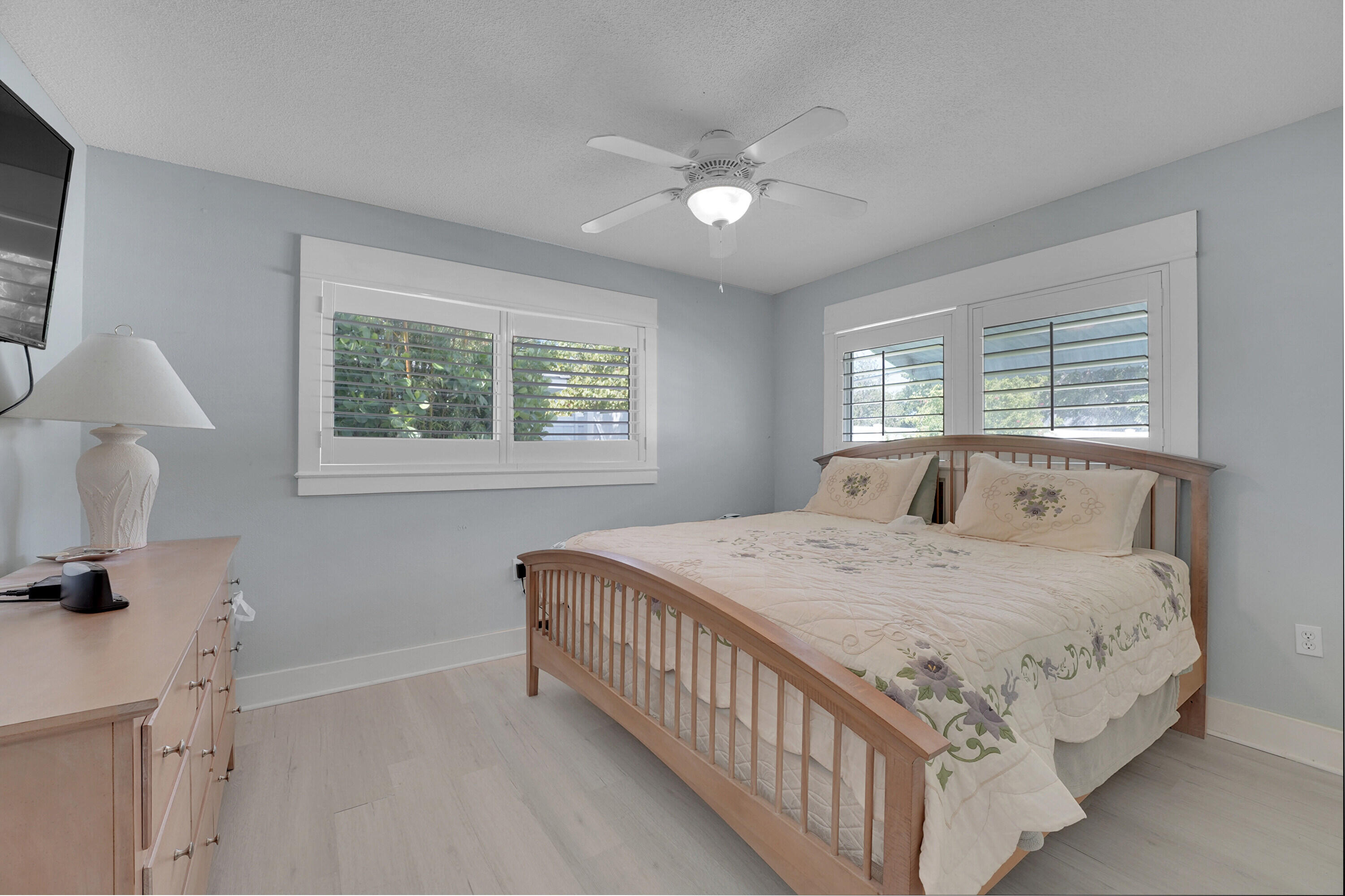 1708 Sunset Isles Road Fort Pierce, FL 34949 - Photo 19 of 52 a bedroom with a bed and a chandelier