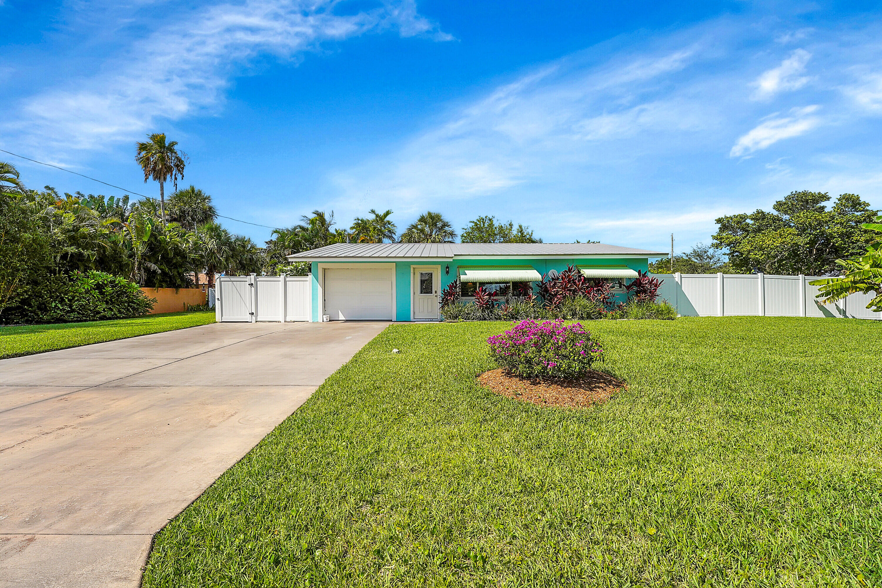 1708 Sunset Isles Road Fort Pierce, FL 34949 - Photo 2 of 52 a front view of a house with garden