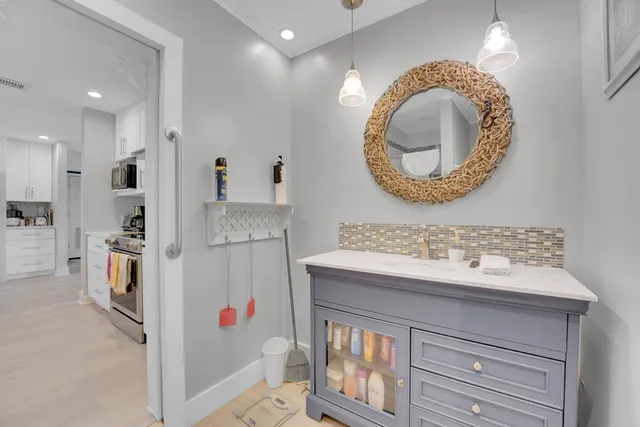 a bathroom with a sink a mirror and a shower
