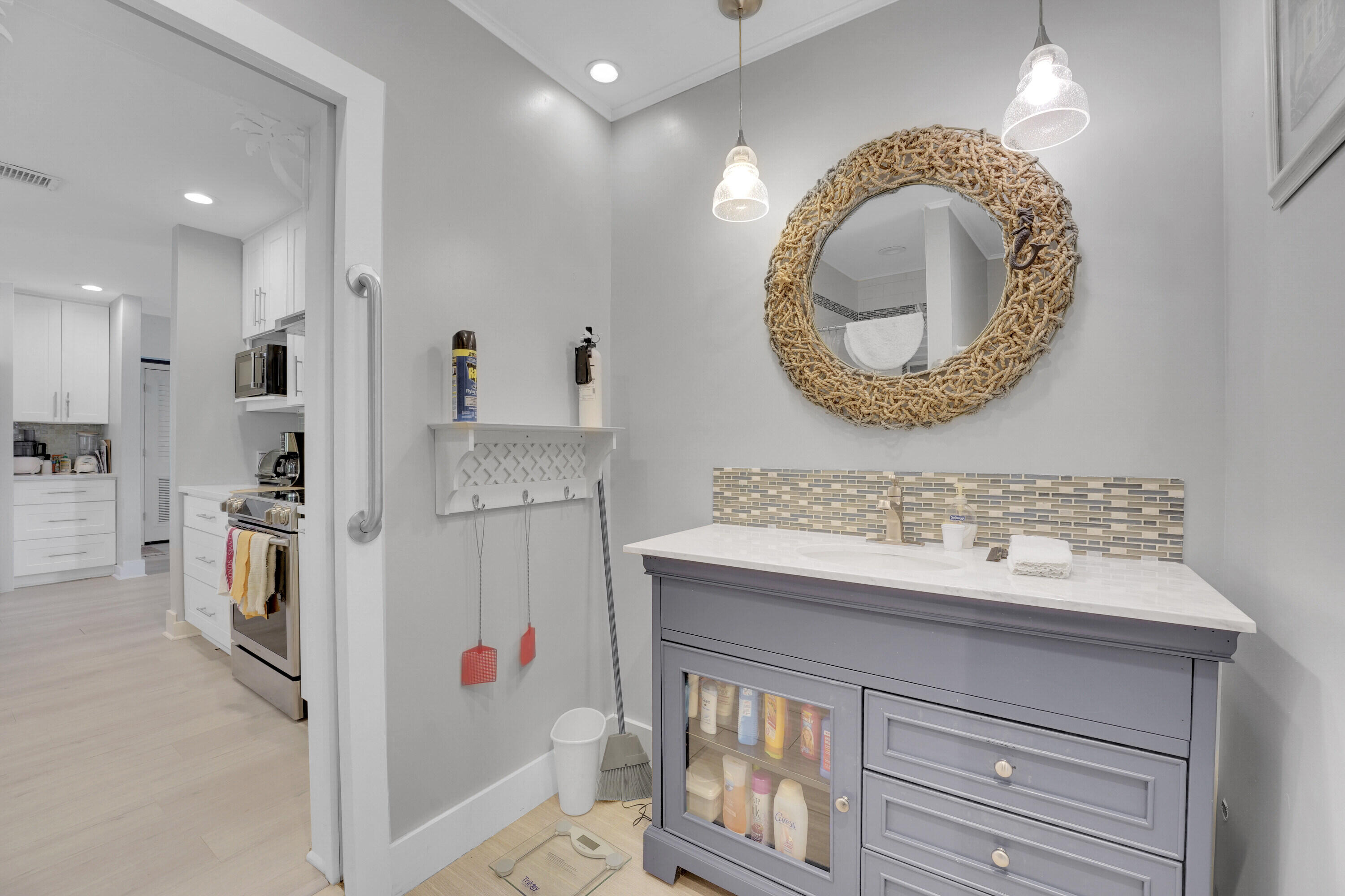 1708 Sunset Isles Road Fort Pierce, FL 34949 - Photo 23 of 52 a bathroom with a sink a mirror and a shower