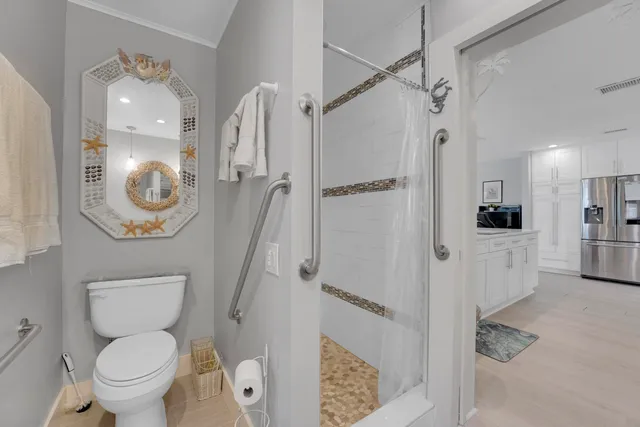 a bathroom with a toilet a sink and a shower
