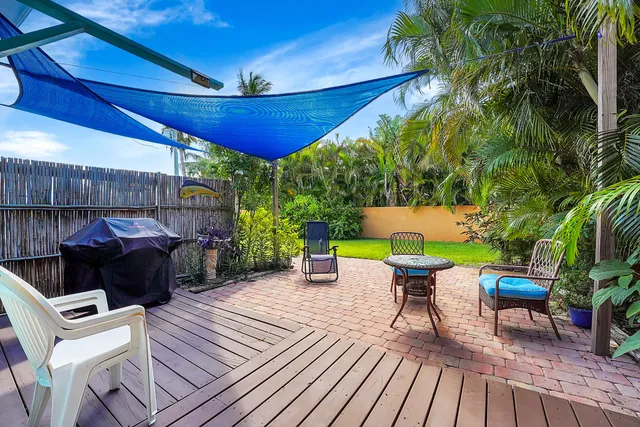 a view of a patio with table and chairs potted plants with wooden floor