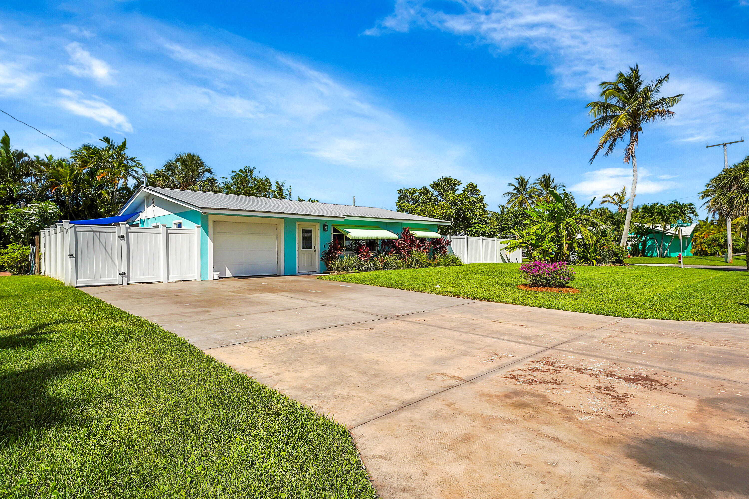 1708 Sunset Isles Road Fort Pierce, FL 34949 - Photo 3 of 52 a front view of a house with a yard and garage