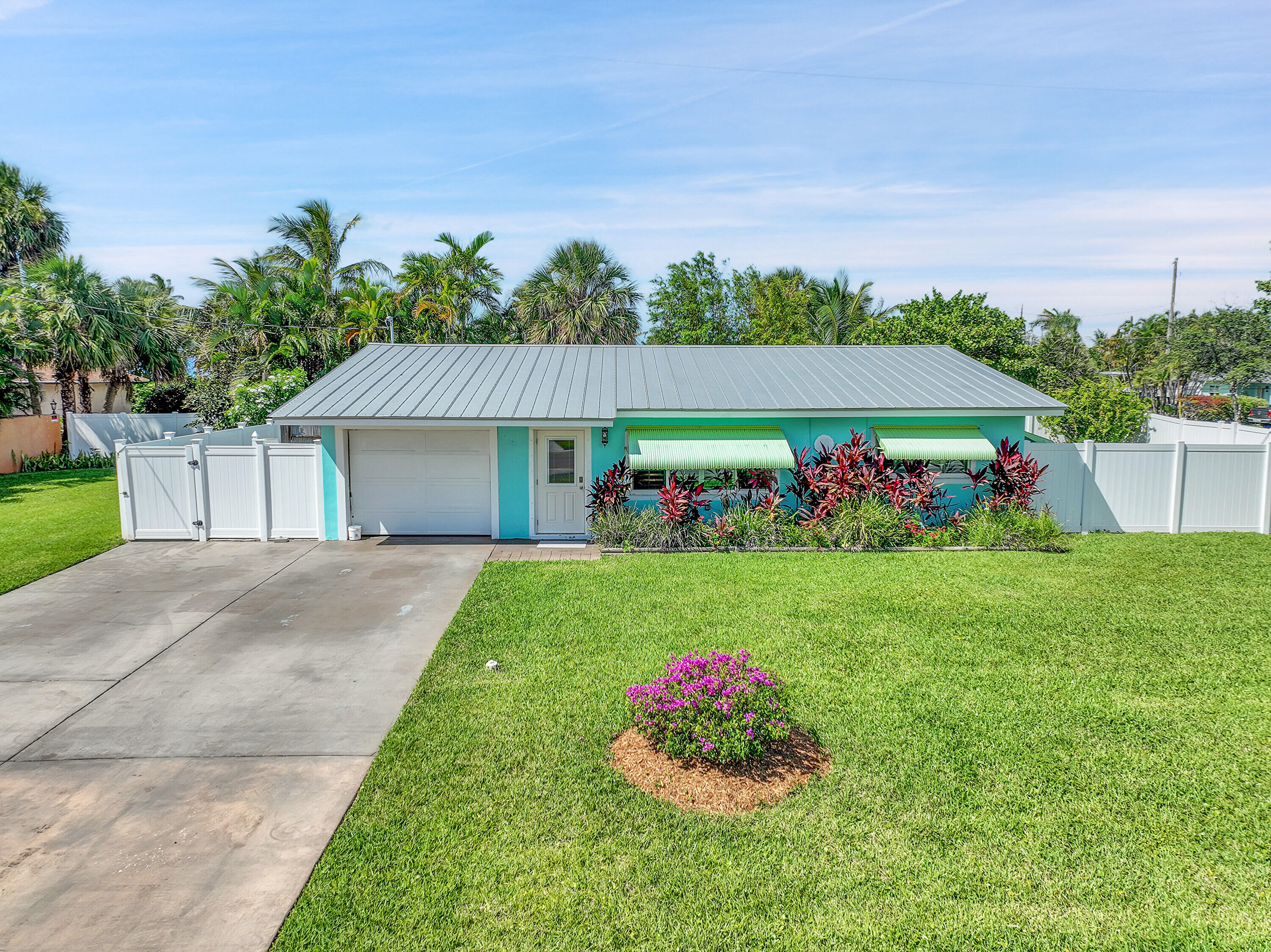 1708 Sunset Isles Road Fort Pierce, FL 34949 - Photo 36 of 52 a front view of house with garden and flowers