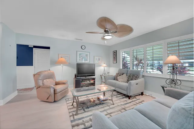 a living room with furniture a fireplace and a large window