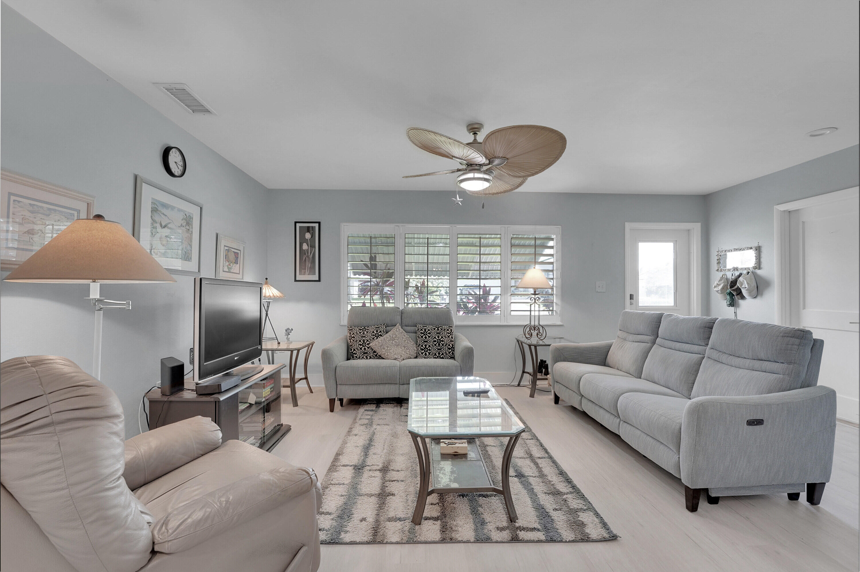 1708 Sunset Isles Road Fort Pierce, FL 34949 - Photo 10 of 52 a living room with furniture ceiling fan and a large window