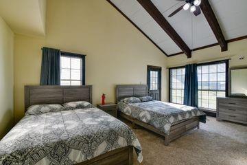 11470 Massey Road Pilot Point, TX 76258 - Photo 8 of 39 a bedroom with two beds lamp and a large window