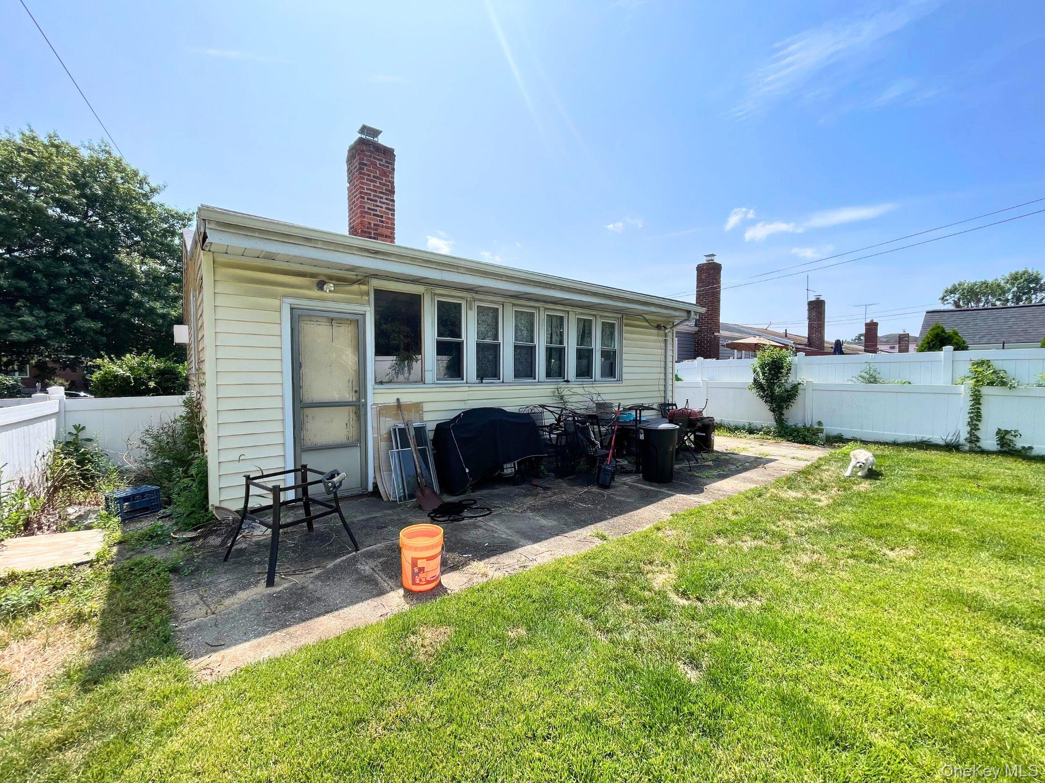 128-10 236th Street Queens, NY 11422 - Photo 3 of 5 a view of a house with backyard porch and sitting area