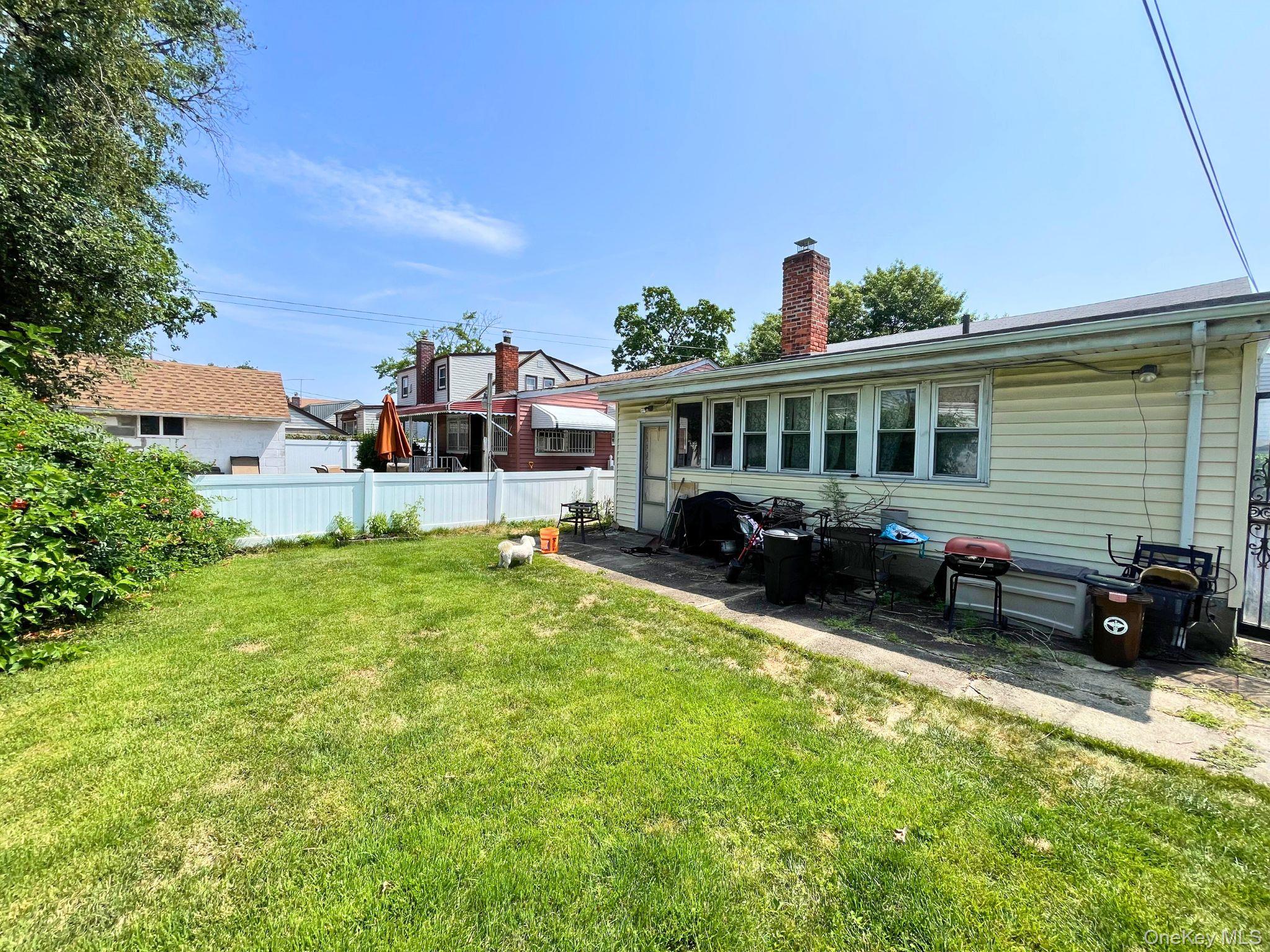 128-10 236th Street Queens, NY 11422 - Photo 4 of 5 a view of a house with a yard
