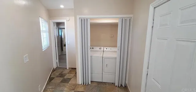 an empty room with closet and mirror