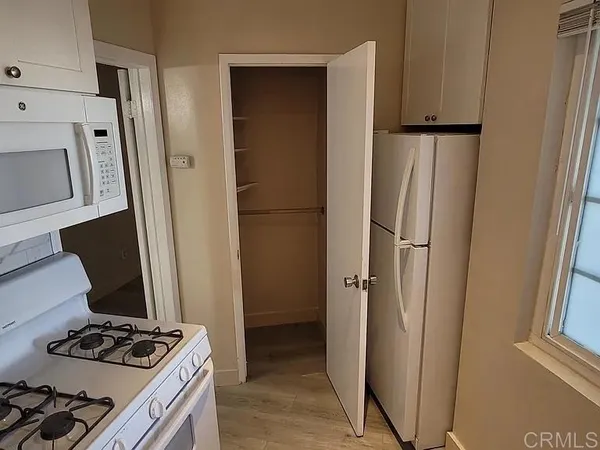 a kitchen with a refrigerator and a stove