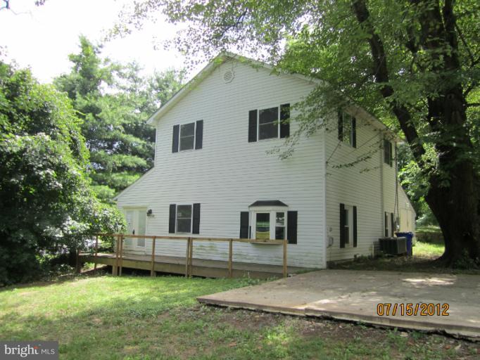 5129 Old National Pike Frederick, MD 21702 - Photo 1 of 14 a white house that has a tree in front of it