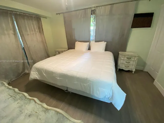 a bedroom with a bed and a mirror