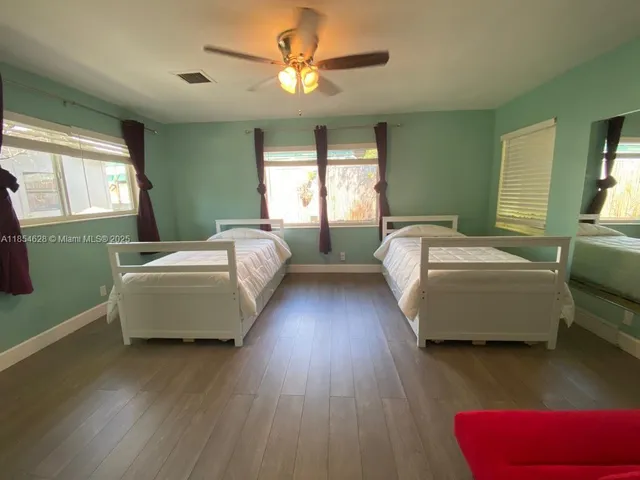 a bedroom with bed and window