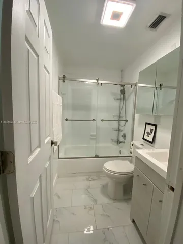 a bathroom with a shower and a toilet